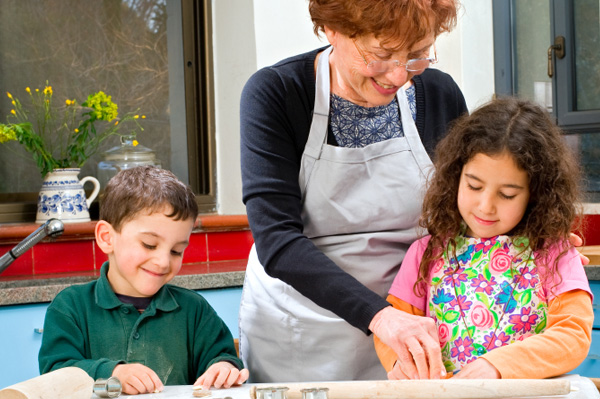 Grandmother cooking with grandchildren