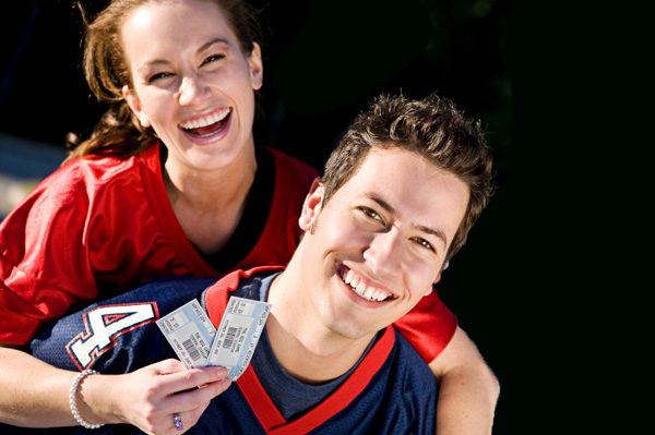 Happy Couple with Football Tickets