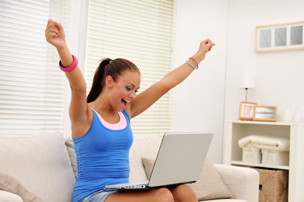 Woman cheering at computer