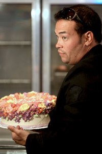 Jon brings the cake for the twins birthday