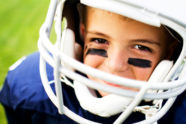 Little boy in football helmet