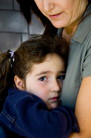 Little Girl Holding onto Mother