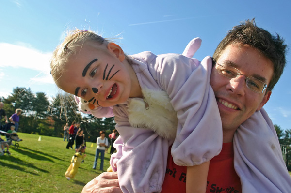 Little girl in rabbit costume on father