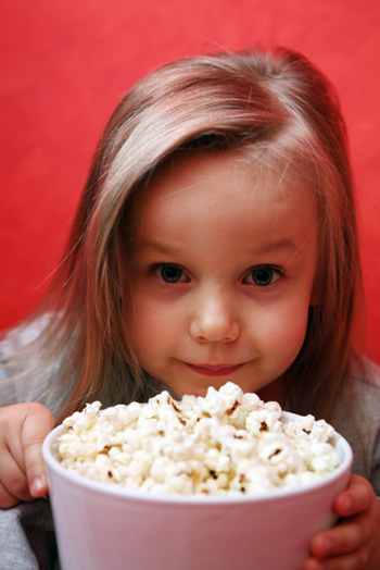 Little Girl with Popcorn How can foods affect your child's behavior