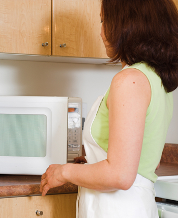 Woman Cooking in the Microwave