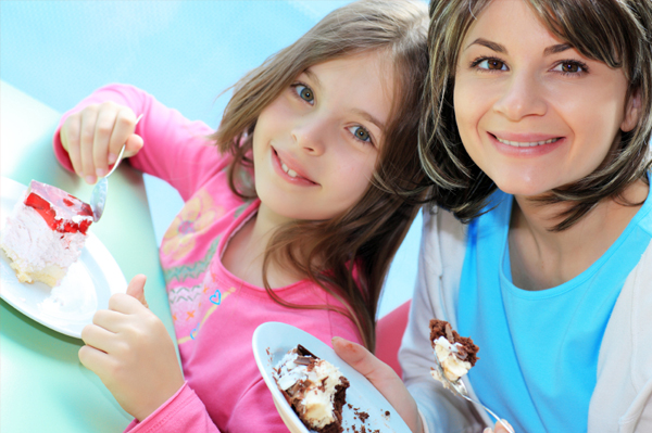 Mom and daughter eating cake