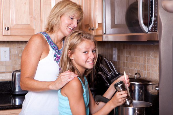 Mom with tween girl cooking