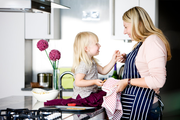Mom baking Valentine's Day cookies with daughter