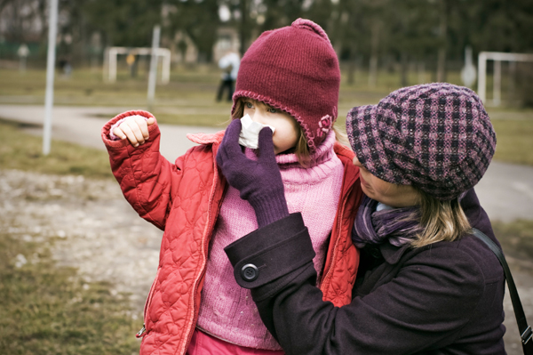 Mom covering nose of child