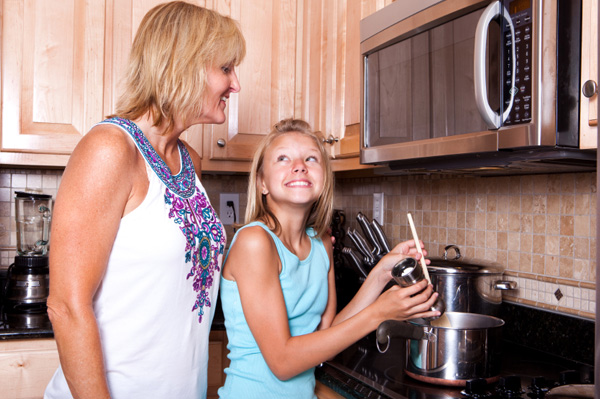 Mom and daughter cooking soup