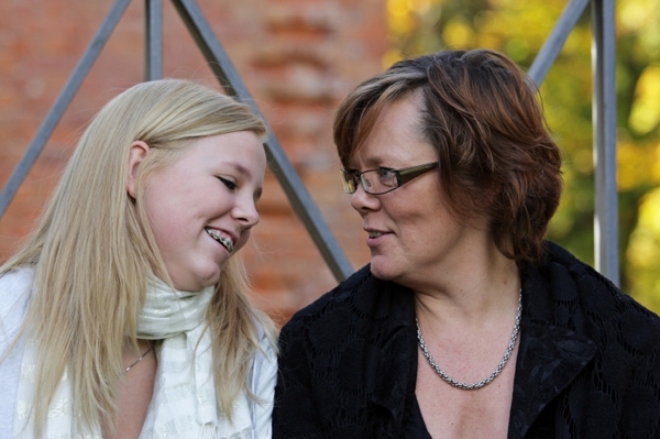 Mom and teen daughter chatting outside