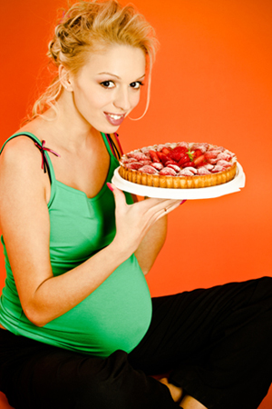 pregnant woman eating. Pregnant Woman with Pie