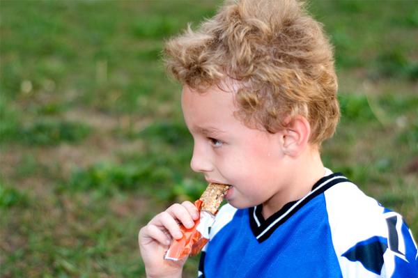 Soccer boy eaitng snack