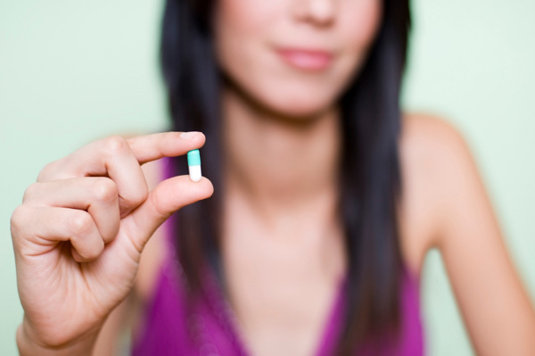 Woman with Vitamin D Pill
