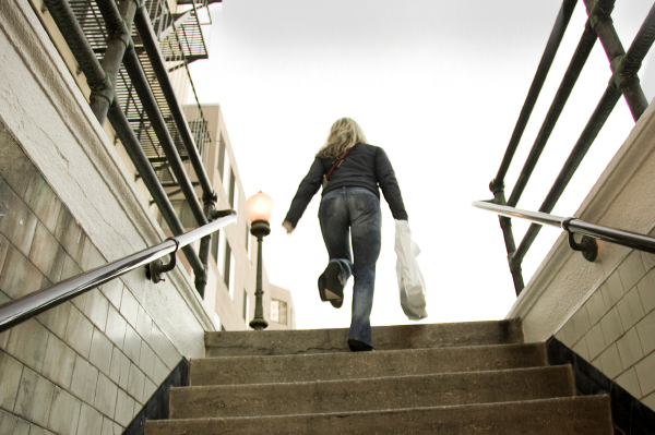 Woman climbing stairs in winter