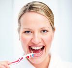 Woman brushing white teeth