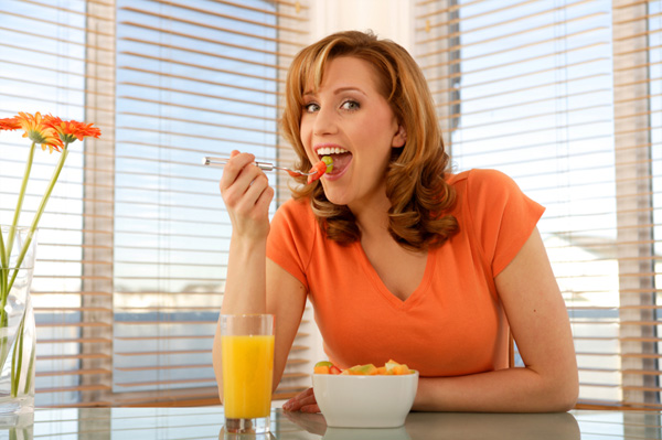 Woman eating fruit salad