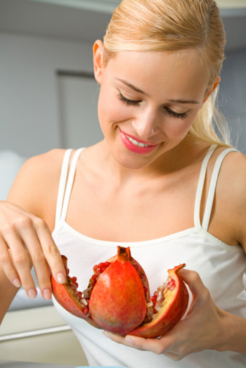 Woman eating pommegranate