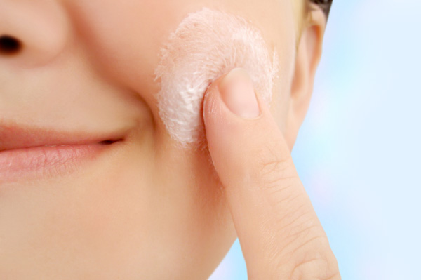 Woman Exfoliating Face