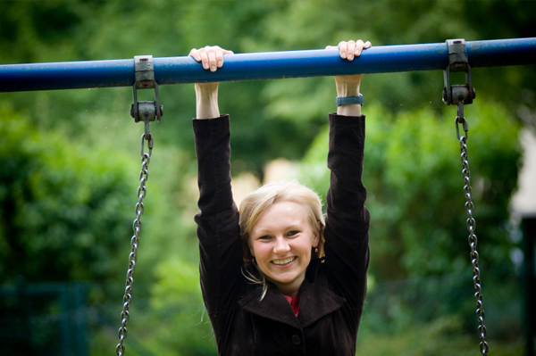 Woman hanging on swing set