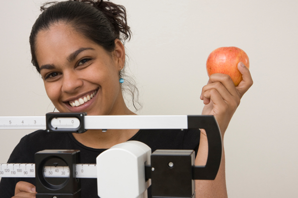 Woman on Scale with Apple