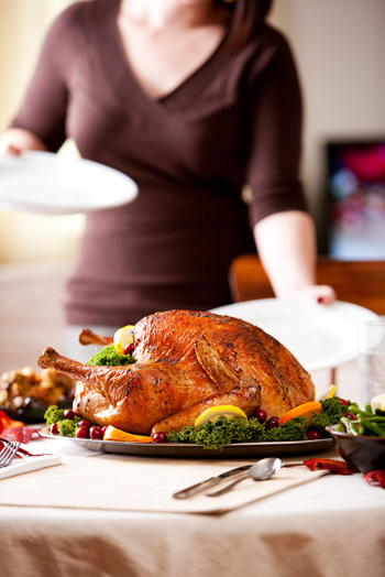 Woman setting Thanksgiving table