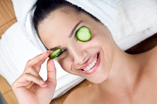 Woman with cucumbers on the face