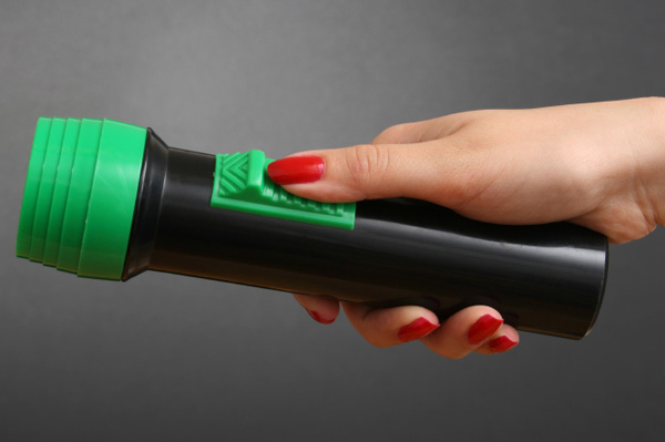 Woman's hand holding flashlight