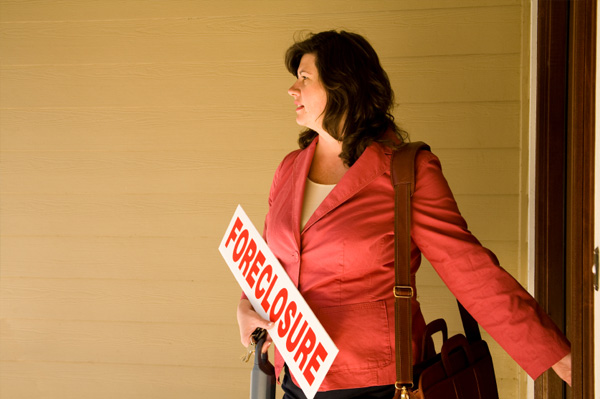 Woman with Foreclosure Sign