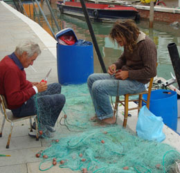 fishermen.jpg fishermen repairing nets in Burano, Italy