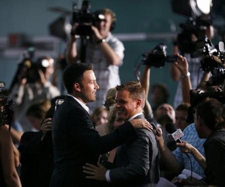 Ben Affleck and Matt Damon are surrounded by the press