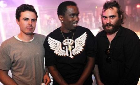 Puff Daddy looks at Joaquin Phoenix at a pre-New Year's Eve party