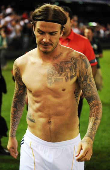 David Beckham takes his top off 