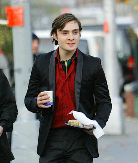 Ed Westwick is carrying food and a drink during a break