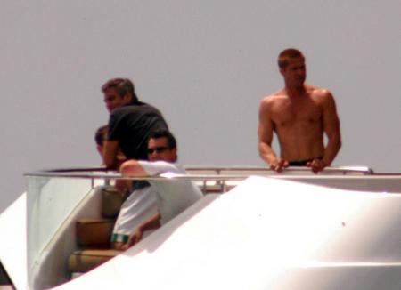 George Clooney and Brad Pitt on a boat while on vacation
