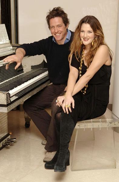 Hugh Grant and Drew Barrymore pose in front of a piano during a photocall for their film 'Music and Lyrics.'