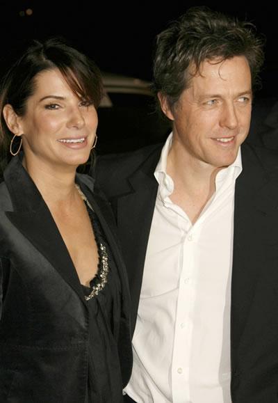 Hugh Grant greets old friend Sandra Bullock at the premiere of 'Music and Lyrics.'