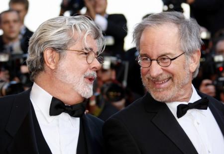 Spielberg and Lucas share a word during a movie premiere