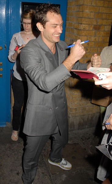 Jude Law happily signs autographs for fans