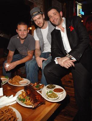 Justin Timberlake and Trace Ayala pose next to dinner