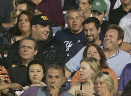 Kevin James and Adam Sandler chuckle in their seats