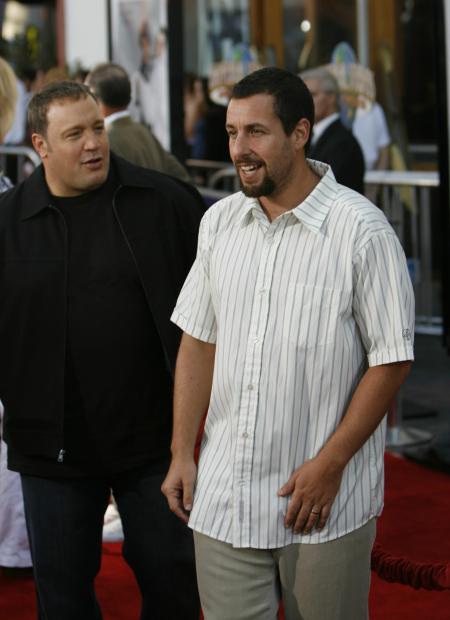 Kevin James says something to Adam Sandler on the red carpet