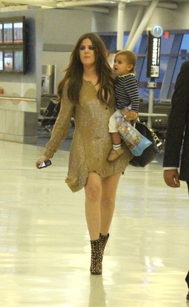 Khloe Kardashian in gold studded boots
