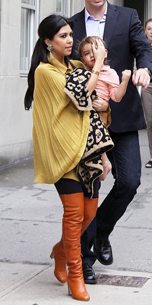 Kourtney Kardashian in gold cape