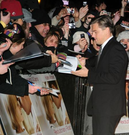 Leonardo DiCaprio signs autographs for fans at a movie premiere