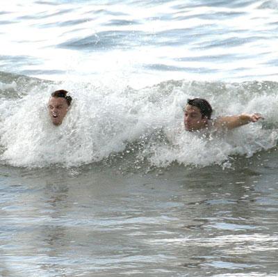 Leonardo DiCaprio and Tobey Maguire swimming at the beach in Hawaii