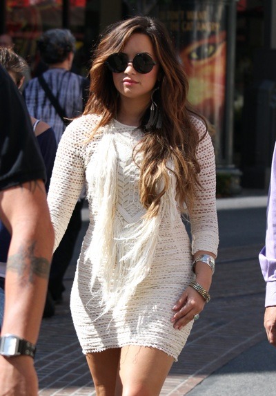 Demi Lovato strolls the streets in a white crochet mini dress