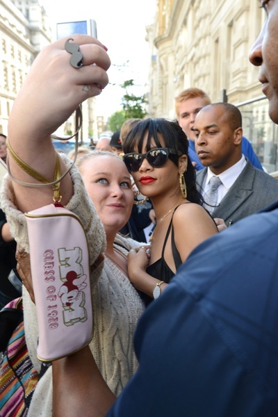 Rihanna poses with fan