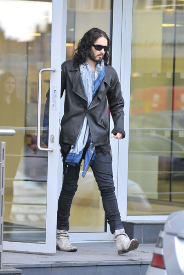 Russell Brand leaves an office in Central London