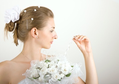 Wedding hairstyles Side Part Bun with Flower Accent
